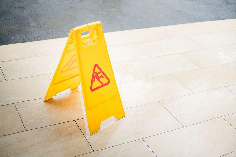 Caution sign warning of a wet floor in a public building